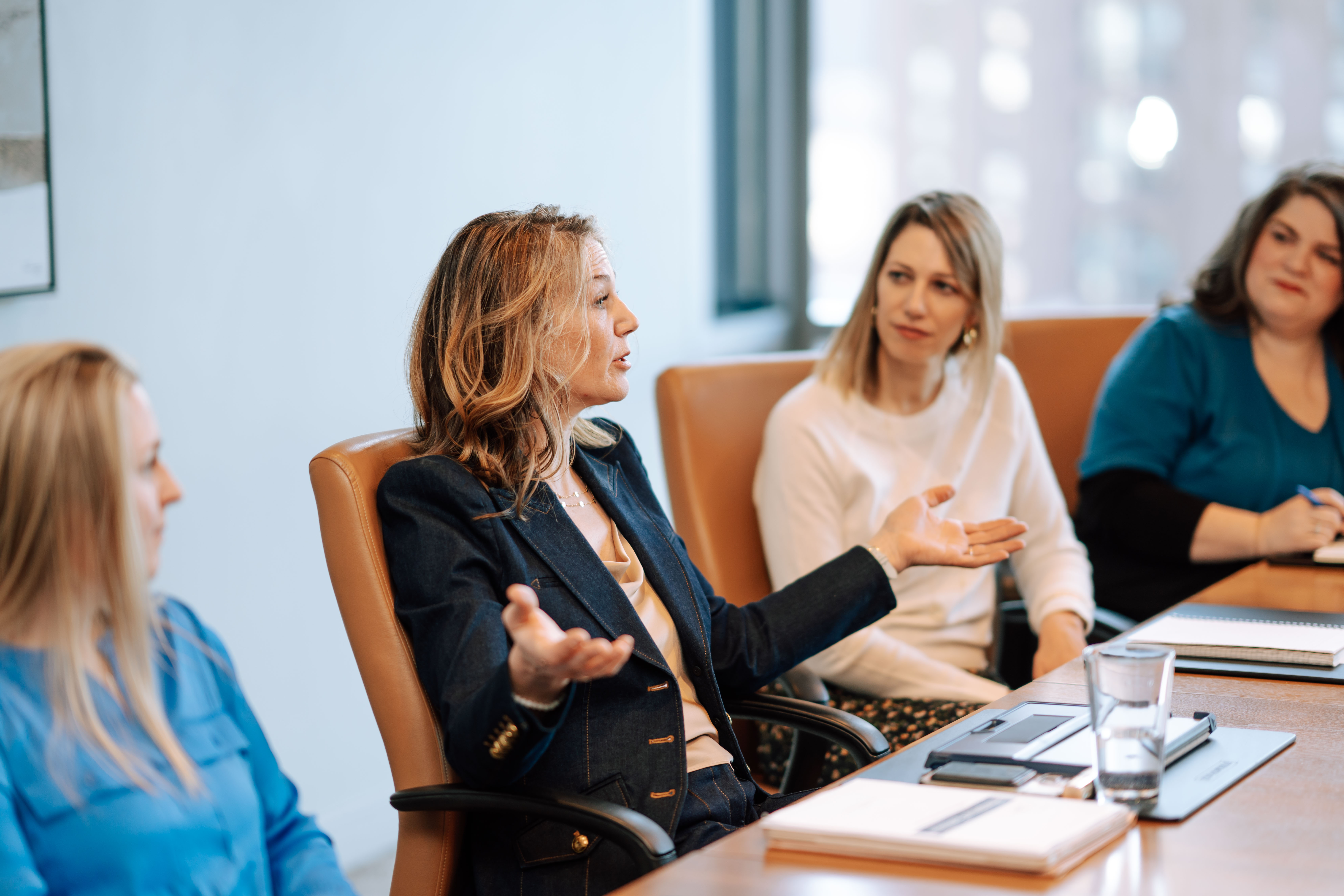 Kari Zeller leading a discussion in a boardroom setting